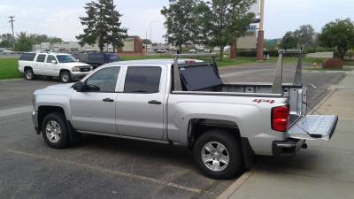 A BAK Flip tonneau cover with an Adarac Pro ladder rack on a Chevy Silverado